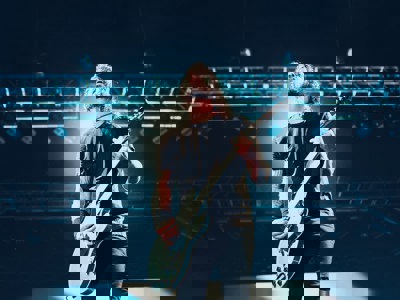 Dave Grohl playing guitar under stage light